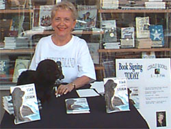 Joan signing books